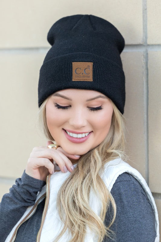 Woman smiling while wearing a CC Heathered Boyfriend Beanie.