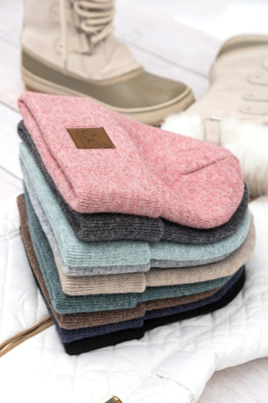 Woman smiling while wearing a CC Heathered Boyfriend Beanie.