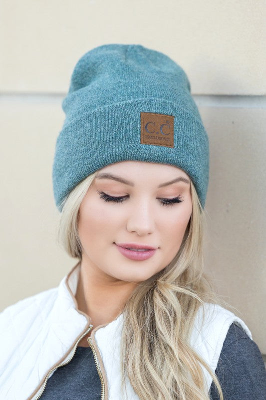 Woman smiling while wearing a CC Heathered Boyfriend Beanie.