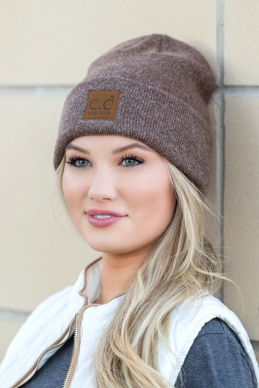 Woman smiling while wearing a CC Heathered Boyfriend Beanie.