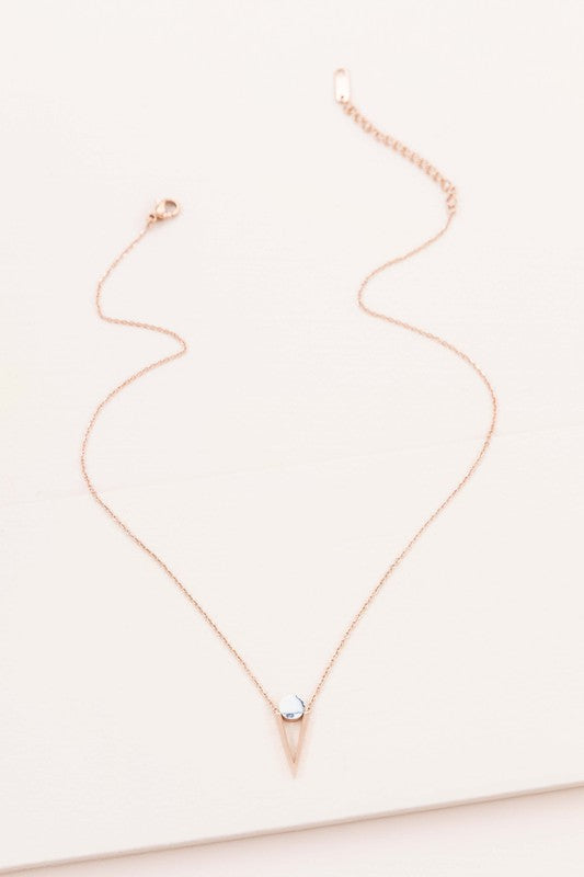 Three Tensly Point Stone Necklaces in rose gold boast a triangular charm pendant, each embellished with a natural stone available in white, turquoise, or black, elegantly displayed side by side.