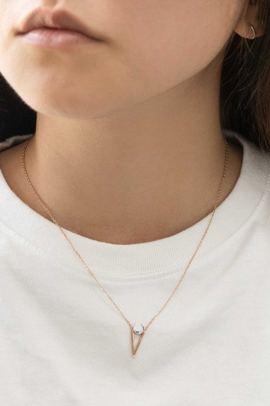 Three Tensly Point Stone Necklaces in rose gold boast a triangular charm pendant, each embellished with a natural stone available in white, turquoise, or black, elegantly displayed side by side.