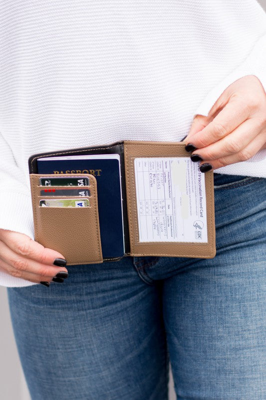 Individual holding an open Passport and Vaccine Credit Card Wallet in vegan leather with a leopard-print design, containing a passport, boarding pass, vaccine card holder, and various cards.