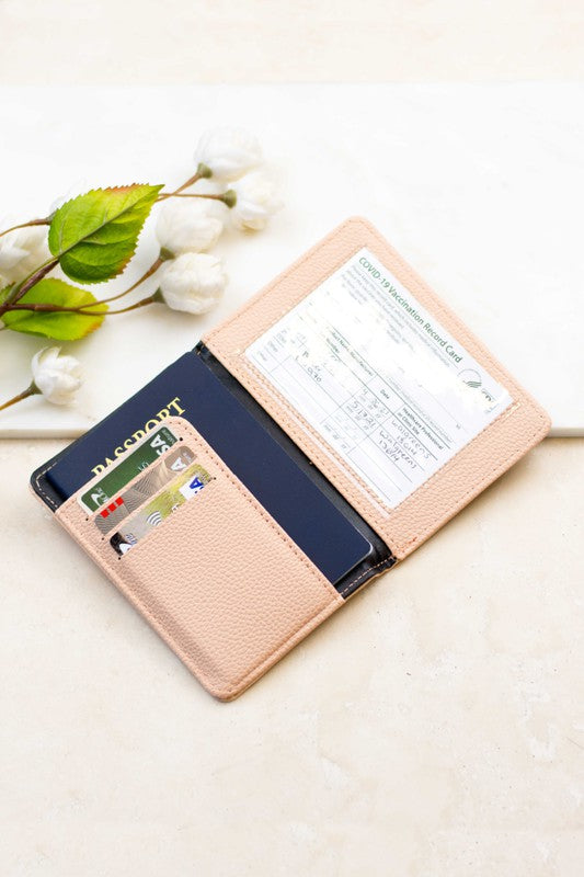 Person holding the Passport and Vaccine Credit Card Wallet made from stylish vegan leather with a leopard print, containing a passport, boarding pass, vaccine card holder, and several cards.