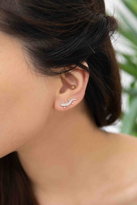 Three pairs of Lizard Ear Pin Earrings, featuring captivating stone-studded designs in gold, rose gold, and silver-plated brass jewelry, are elegantly presented on a light surface.