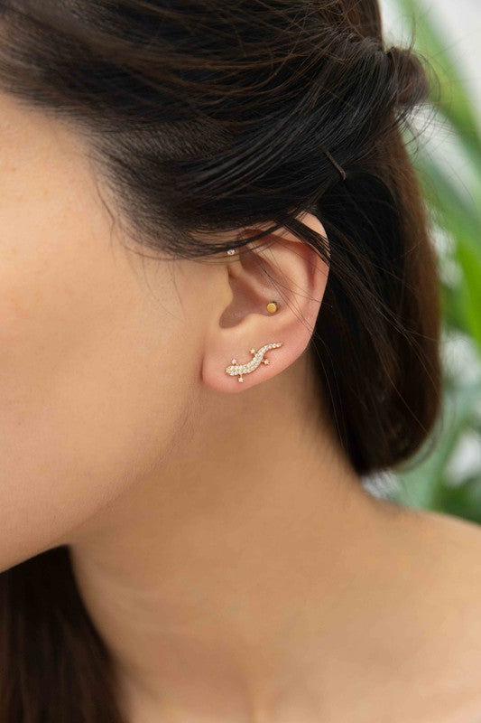 Three pairs of Lizard Ear Pin Earrings, featuring captivating stone-studded designs in gold, rose gold, and silver-plated brass jewelry, are elegantly presented on a light surface.