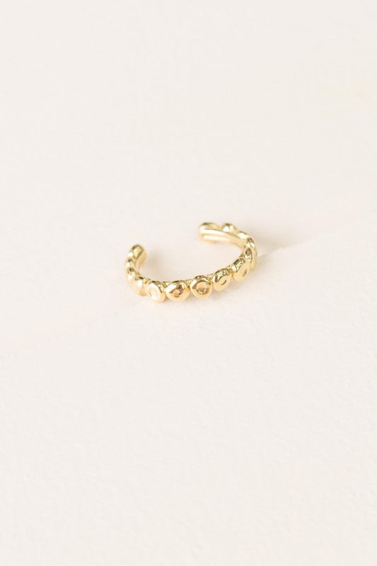 The Bubbling Adjustable Ring, featuring a textured, 14k gold plated design with a scalloped pattern, is showcased on a plain off-white background.