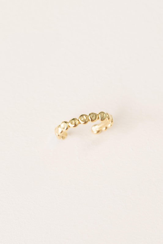 The Bubbling Adjustable Ring, featuring a textured, 14k gold plated design with a scalloped pattern, is showcased on a plain off-white background.