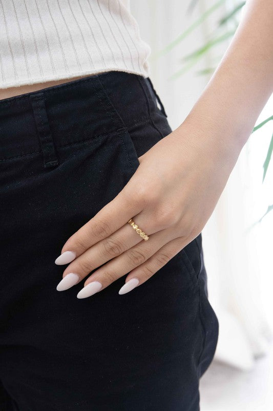 The Bubbling Adjustable Ring, featuring a textured, 14k gold plated design with a scalloped pattern, is showcased on a plain off-white background.