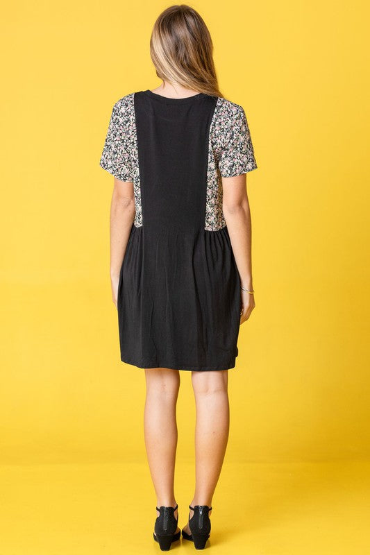 A person wearing the Ditsy Floral Contrast Mini Dress poses against a vibrant yellow background.