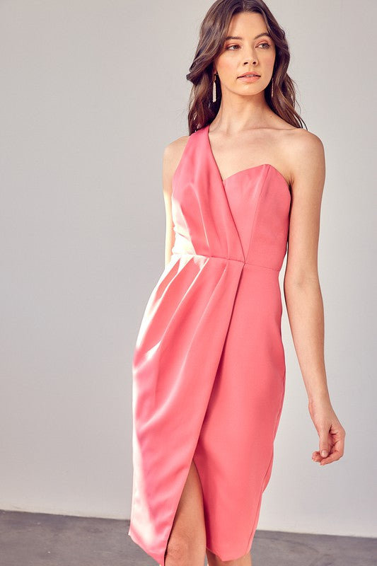 A woman models the "One Shoulder Overlap Dress" in a stylish pink design, highlighting its contemporary fashion with an asymmetrical hem and subtle overlap detail, set against a plain background.