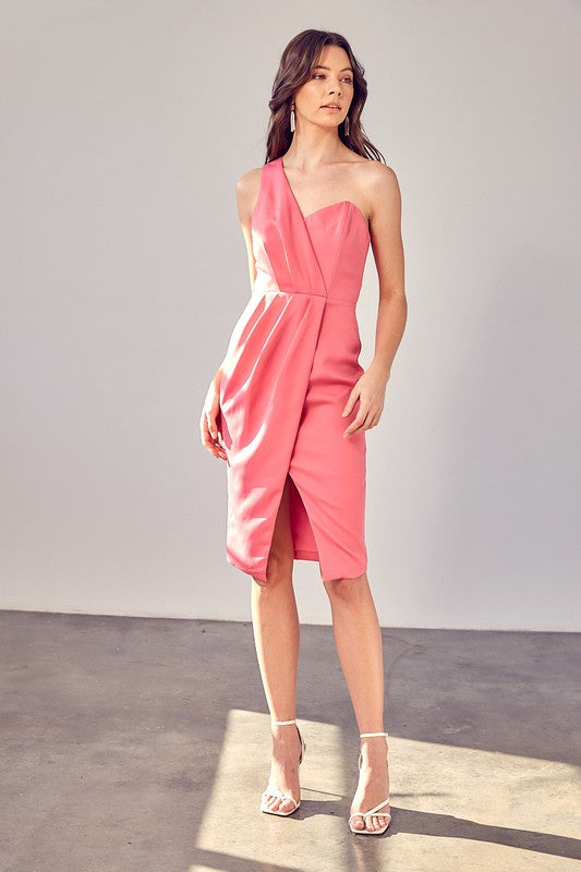 A woman models the "One Shoulder Overlap Dress" in a stylish pink design, highlighting its contemporary fashion with an asymmetrical hem and subtle overlap detail, set against a plain background.