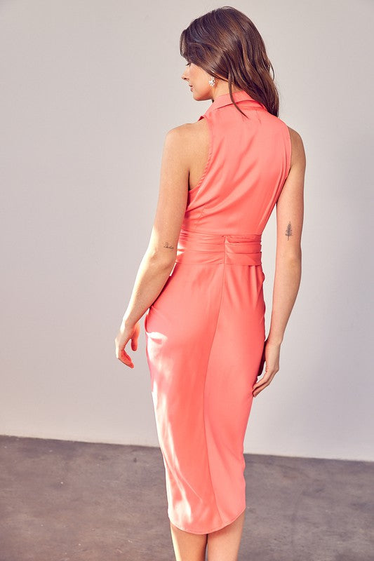 A woman wearing the Sleeveless Collar Front Tie Dress in coral, standing against a plain backdrop.