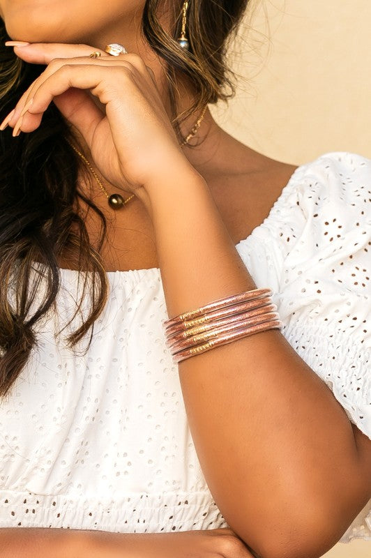 Woman wearing a white blouse and Glitter Jelly Bangle Bracelets.