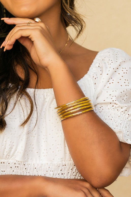 Woman wearing a white blouse and Glitter Jelly Bangle Bracelets.