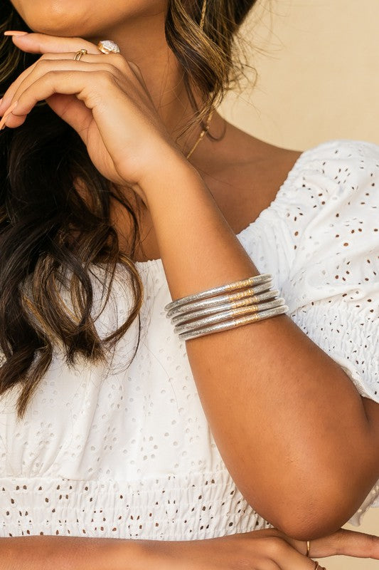 Woman wearing a white blouse and Glitter Jelly Bangle Bracelets.