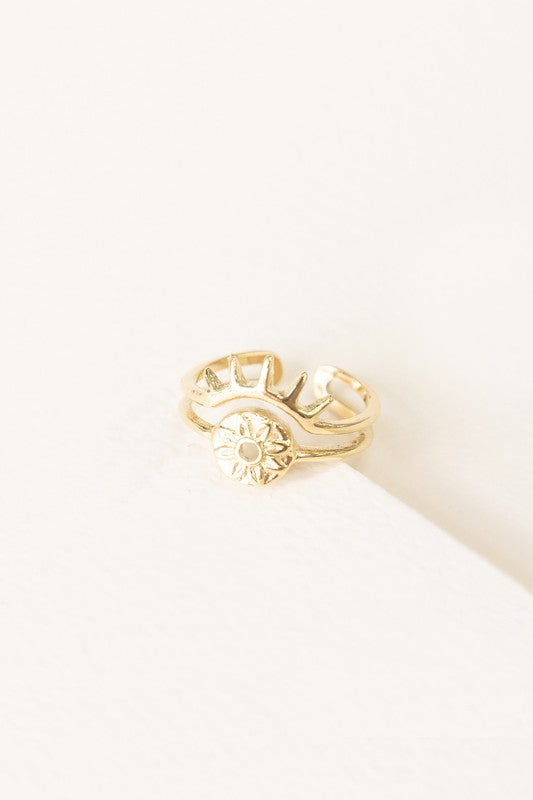 The Eye of the Beholder Adjustable Ring showcases a gold open band design decorated with a sun motif, capturing the spirit of bohemian jewelry.