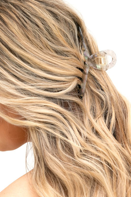 A close-up of dark wavy hair secured with a Resin Loop Claw Clip.