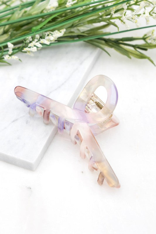 A close-up of dark wavy hair secured with a Resin Loop Claw Clip.