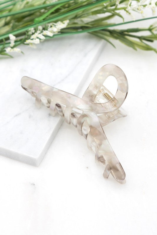 A close-up of dark wavy hair secured with a Resin Loop Claw Clip.