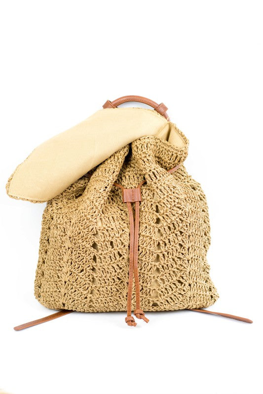 A person wearing a straw hat and white tank top carries the elegant Woven Straw Backpack, featuring charming PU leather straps.