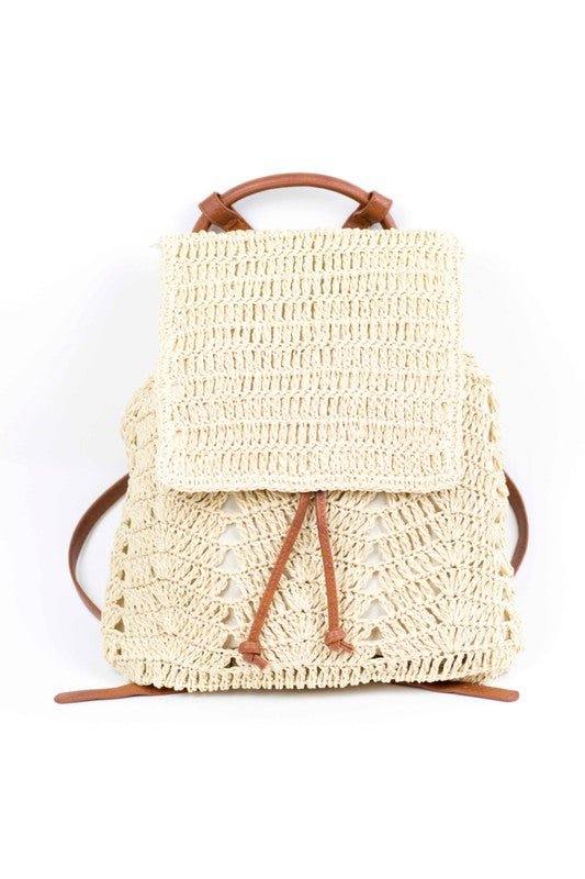 A person wearing a straw hat and white tank top carries the elegant Woven Straw Backpack, featuring charming PU leather straps.