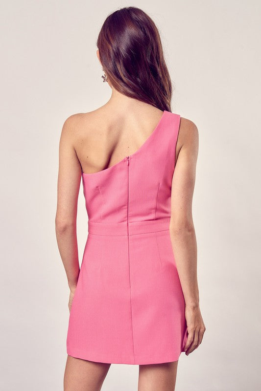 Dressed in the chic Asymmetric One Shoulder Dress in pink and paired with transparent heels, a person poses against a plain backdrop, creating a modern and fashionable look.