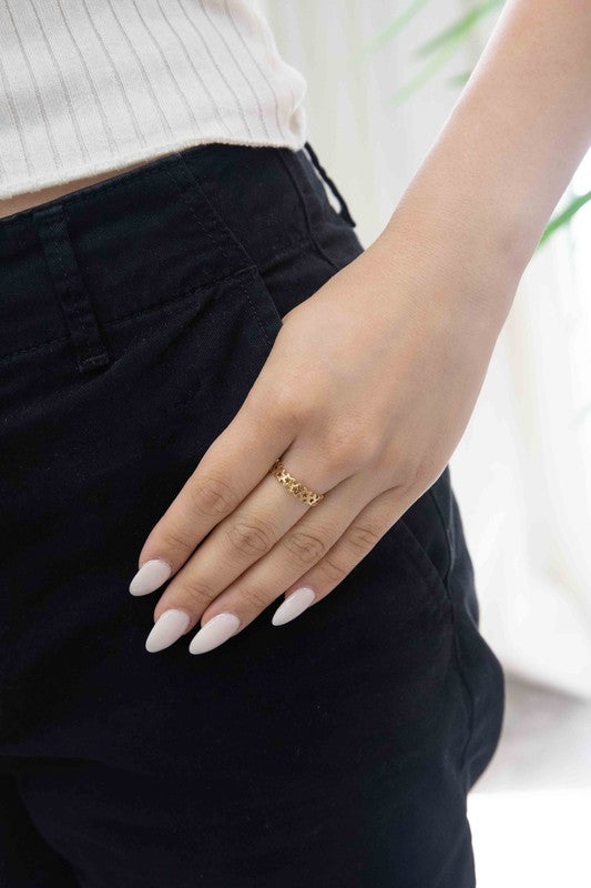 The You're a Star Ring boasts an intricate design of interlinked stars on a subtle background, beautifully crafted from stainless steel and accented with 14k gold plating.