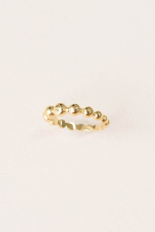 The Bubbly Ring, crafted with 14k gold plating and featuring a beaded design, is showcased against a simple white background.