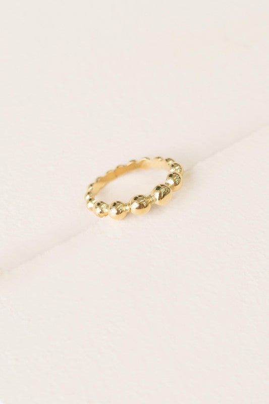 The Bubbly Ring, crafted with 14k gold plating and featuring a beaded design, is showcased against a simple white background.