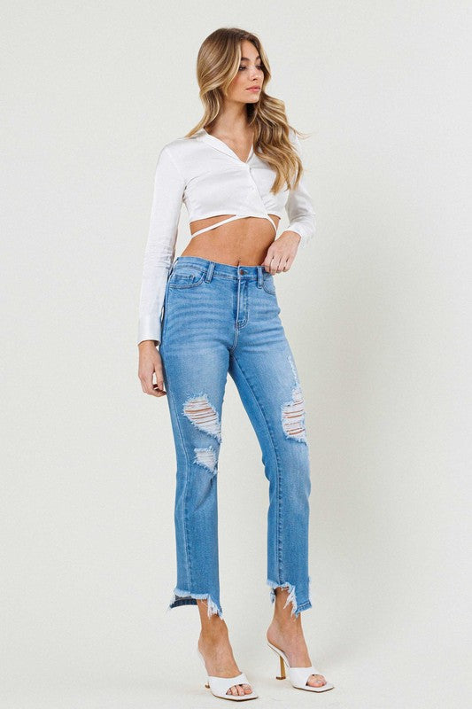 Person wearing light blue Mid Rise Straight Leg jeans with distressed details and white open-toe heels.