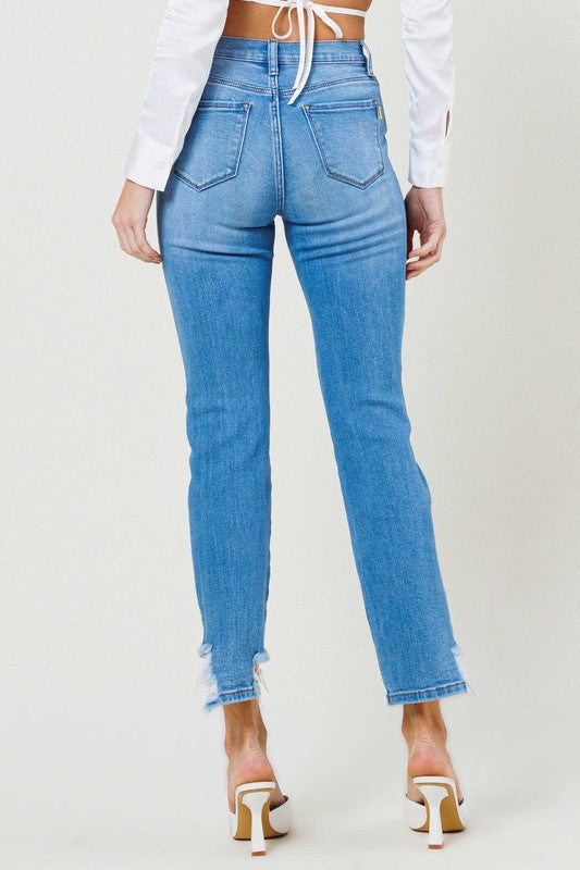 Person wearing light blue Mid Rise Straight Leg jeans with distressed details and white open-toe heels.