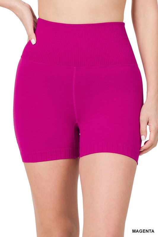 Seamless high-waisted workout shorts with perforated side detail on a female mannequin.