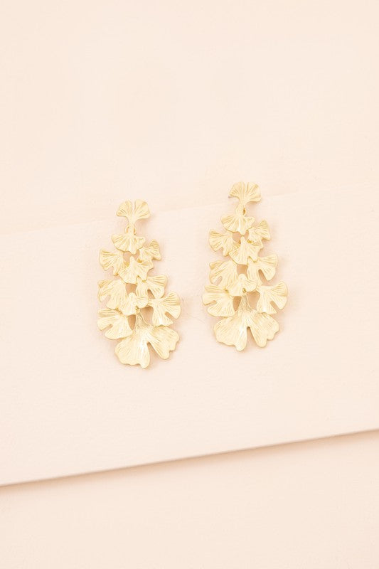 Adiantum Drop Earrings with a tiered leaf design, finished in matte gold and set on a light beige background, complete with a sterling silver post.