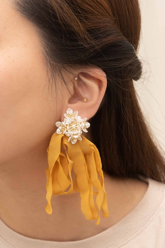 Chasse Dangle Earrings: Peach ribbon earrings adorned with pearl flower clusters set against a cream background, complete with a sterling silver post for a delicate touch.