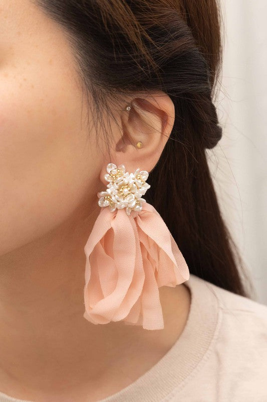 Chasse Dangle Earrings: Peach ribbon earrings adorned with pearl flower clusters set against a cream background, complete with a sterling silver post for a delicate touch.