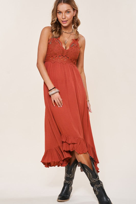 A woman wearing a Long Slip Dress with black lace trim and tan boots poses against a plain background.