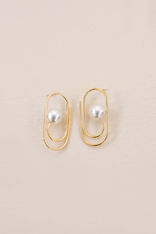 The Workflow Post Earrings showcase a central pearl elegantly positioned on a beige backdrop, each piece secured by a sterling silver post.