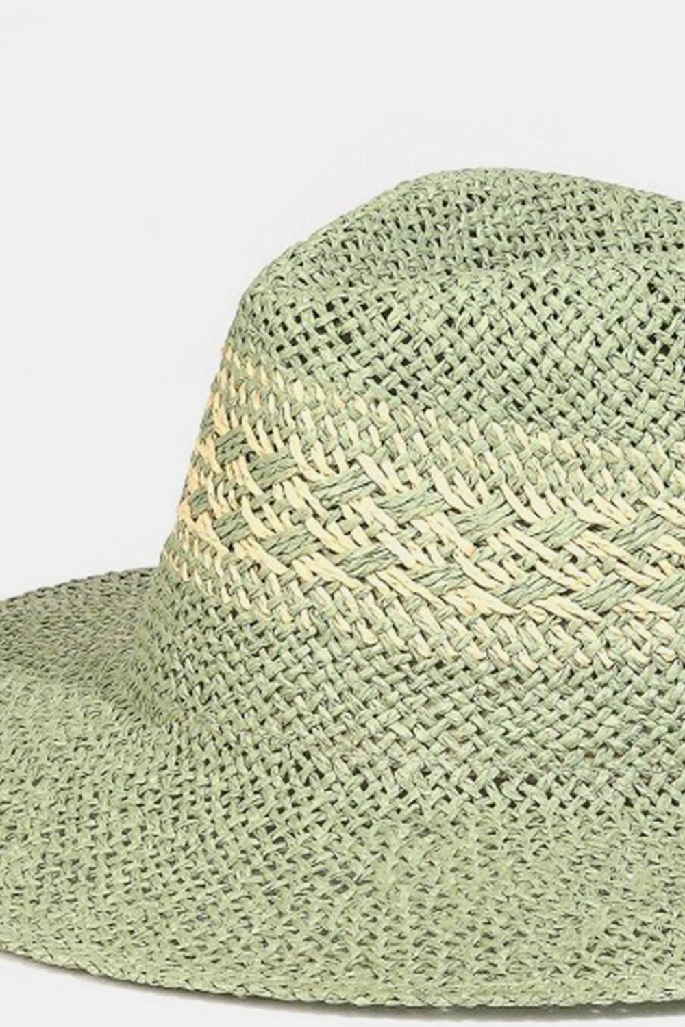 The Fame Contrast Wide Brim Straw Hat in light green, adorned with a decorative band and resting on a plain background, offers a blend of style and effective sun protection.