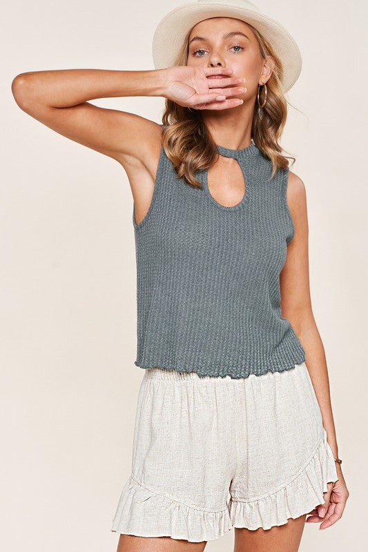 Wearing Joyce Shorts made from cream-colored cotton fabric, paired with brown boots, perfect for a casual wardrobe ensemble.