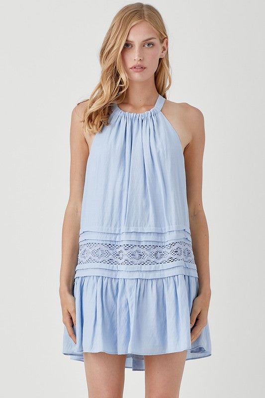 A woman wearing the Halter Neck Trim Lace with Folded Detail Dress in light blue, stands against a plain background.