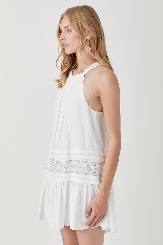 A woman wearing the Halter Neck Trim Lace with Folded Detail Dress in light blue, stands against a plain background.