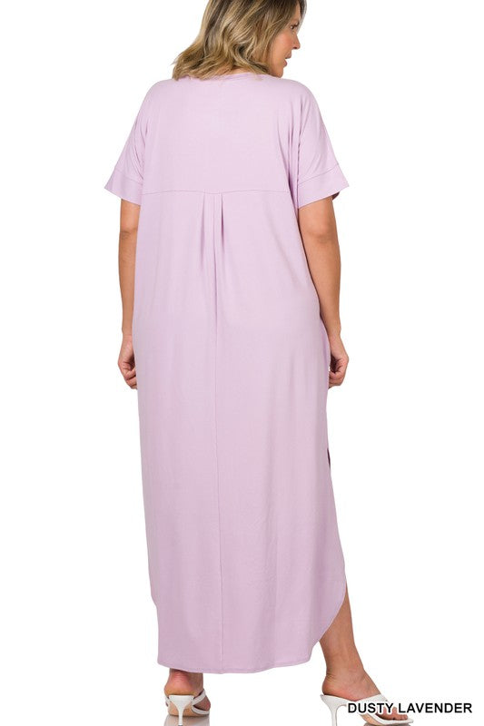 A person wearing the Plus Brushed DTY Short Sleeve Maxi Dress, featuring a vibrant blue color with slits on both sides and a subtle brushed DTY texture, stands in front of a plain white background.