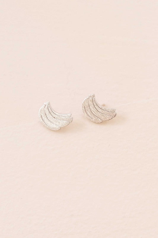 Six pairs of Banana Earrings, crafted in a blend of sterling silver with gold and rose gold accents, are arranged in a neat line on a light background. This collection adds a touch of quirky jewelry charm to any ensemble.