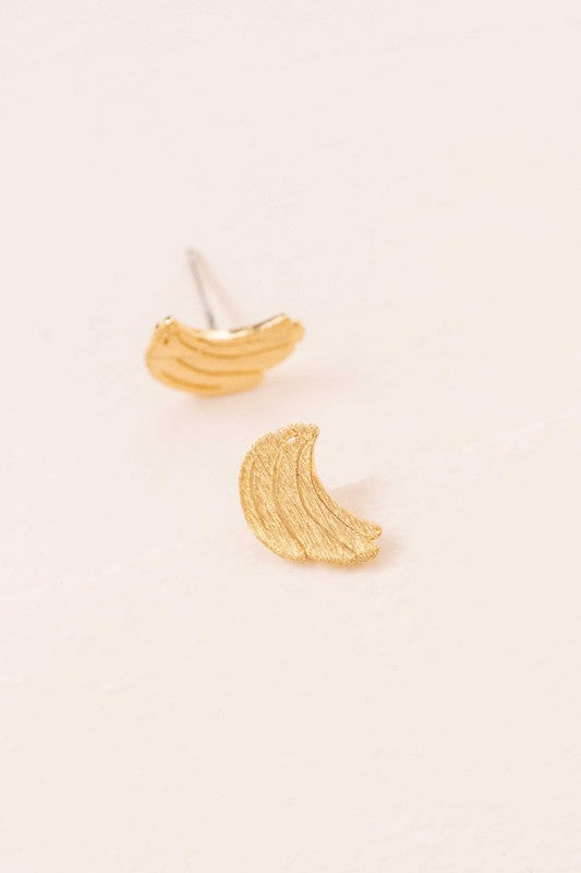 Six pairs of Banana Earrings, crafted in a blend of sterling silver with gold and rose gold accents, are arranged in a neat line on a light background. This collection adds a touch of quirky jewelry charm to any ensemble.