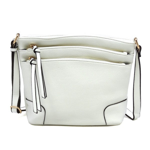 The Fashion Multi Zip Pocket Crossbody Bag is a beige faux leather handbag featuring gold hardware, a front zipper pocket, a two-tone adjustable shoulder strap, and two tassels.