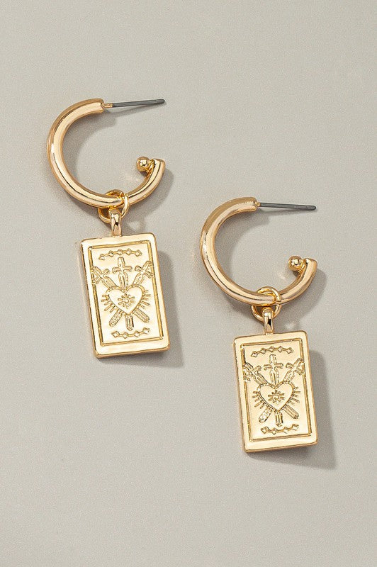 Rectangle drop earrings with etched heart designs, elegantly plated in shiny gold and featuring rectangular pendants, beautifully displayed on a neutral background.