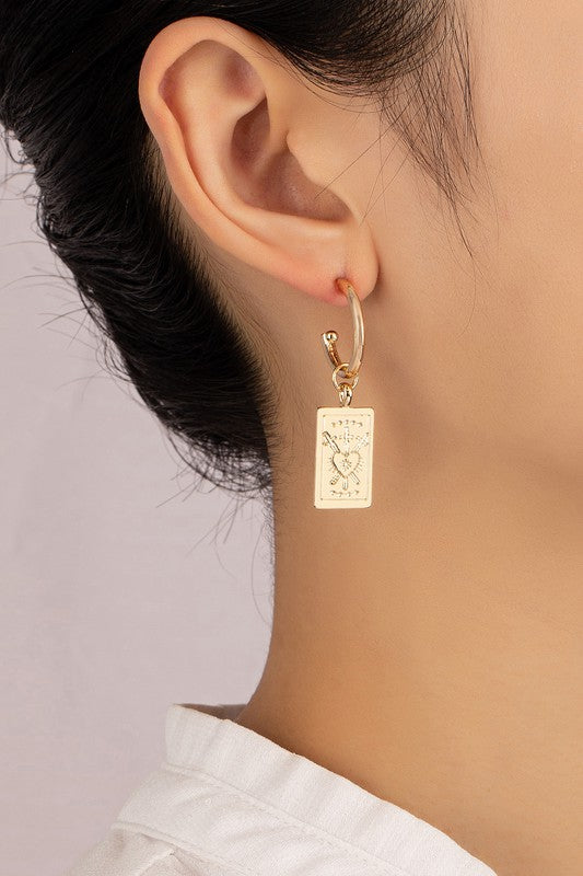 Rectangle drop earrings with etched heart designs, elegantly plated in shiny gold and featuring rectangular pendants, beautifully displayed on a neutral background.