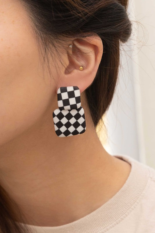 Textile Drop Earrings with a retro design featuring a black and white checkered pattern on a beige background.