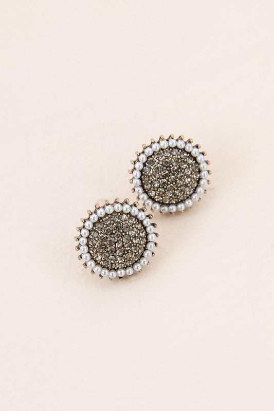 The Refined Stud Earrings showcase vintage gold metal centers encircled by pearls, all set against a light beige backdrop.